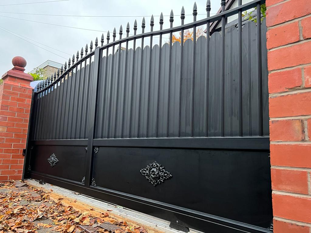 black traditional aluminium gates fixed to brick pillars