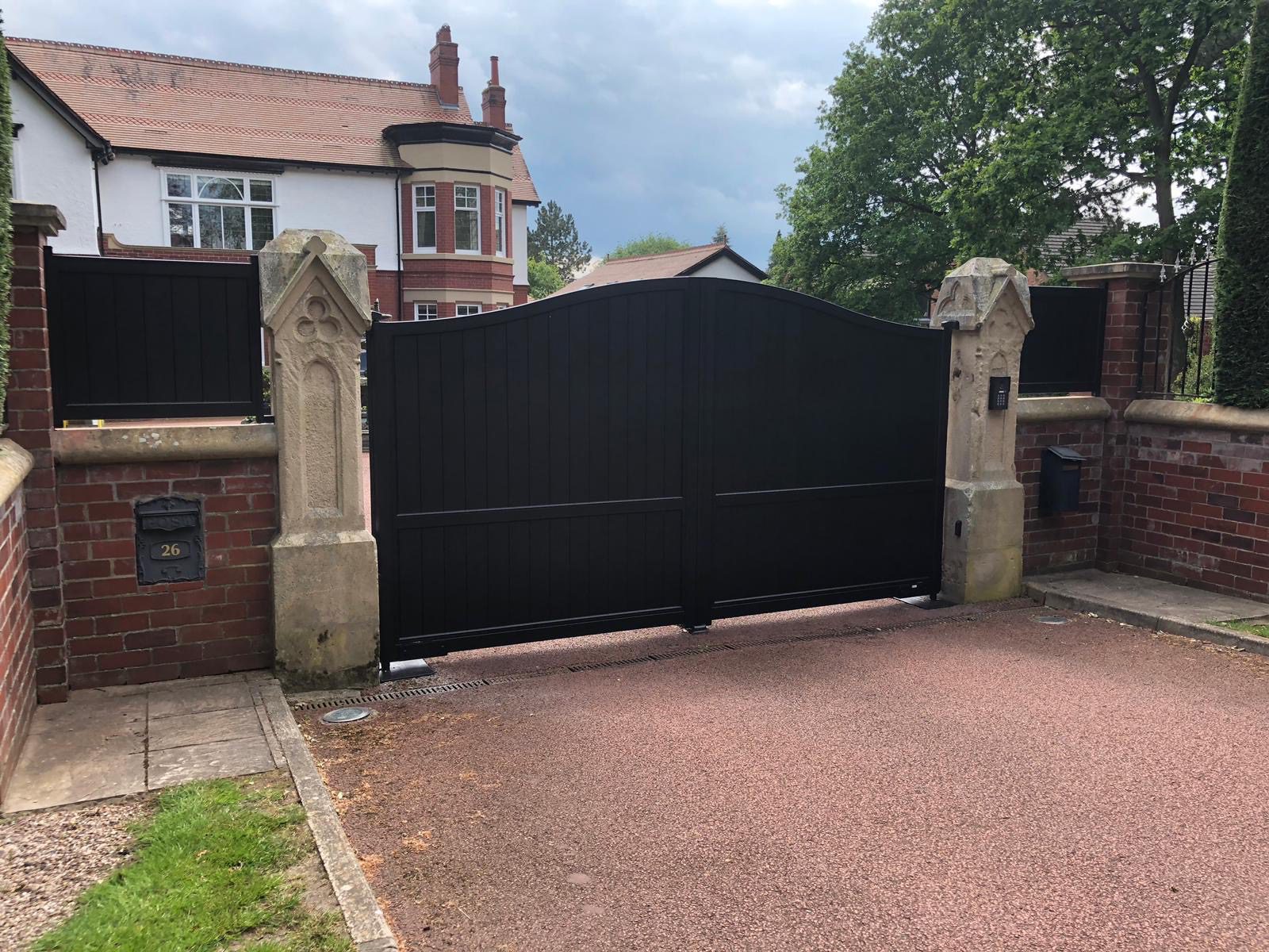 Black aluminium gates fully boarded with archtop
