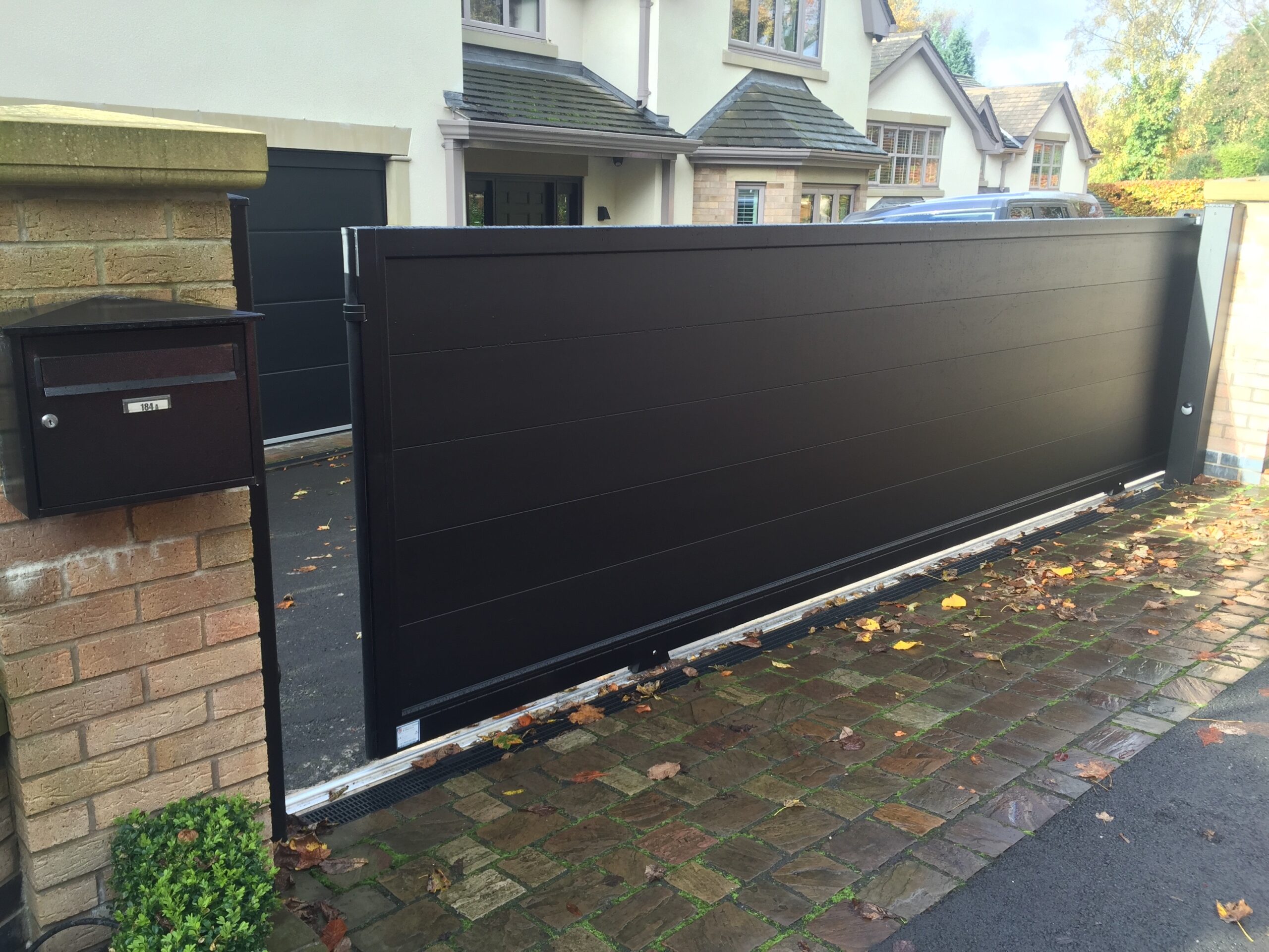black sliding aluminium driveway gates