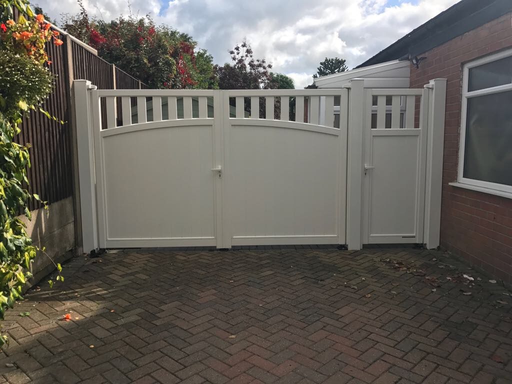 cream coloured manual aluminium gates with pedestrian gate